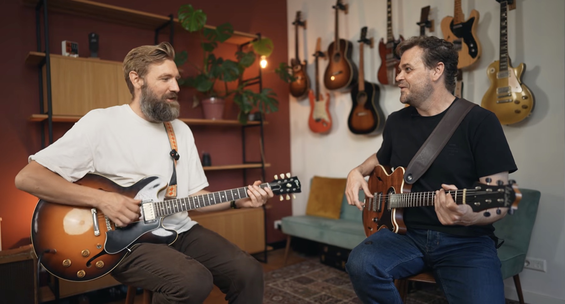 Paul Davids and Adam Miller playing guitar together.